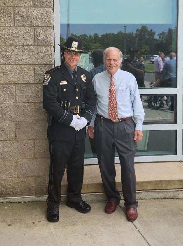 Officer Ethan Kula and First Selectman Tim Griswold 