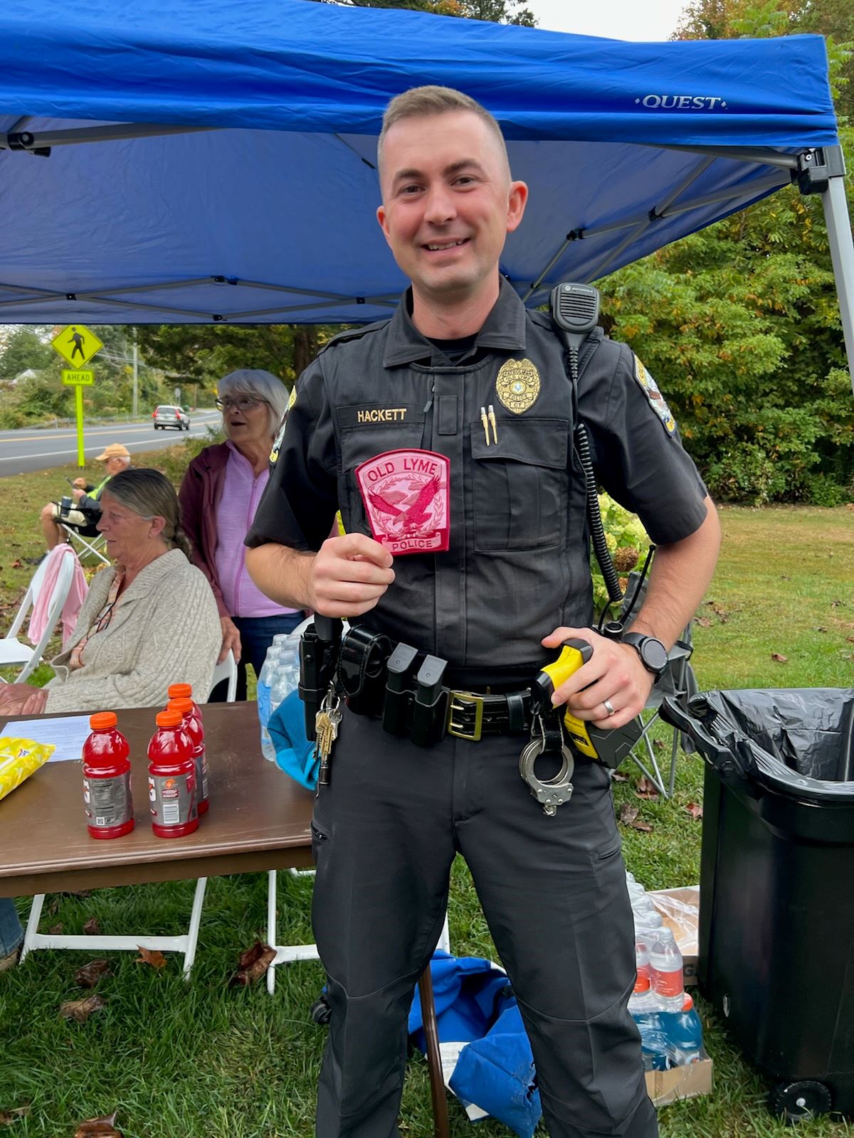 Patrolman Hackett holding a Breast Cancer Pink Old Lyme Police Patch